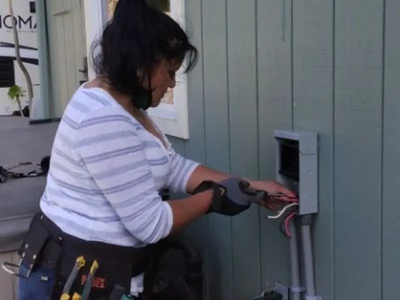 Licensed electrician wiring an exterior subpanel in Point